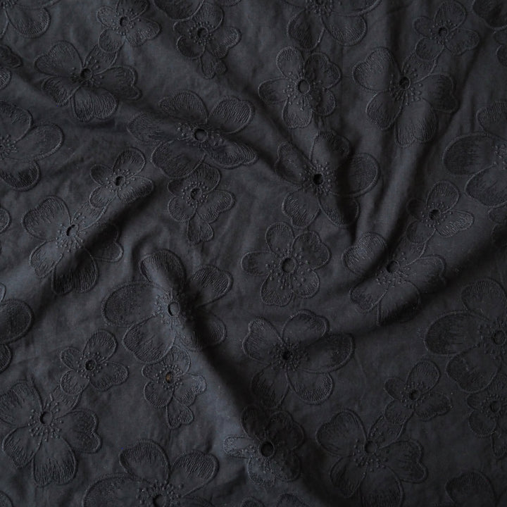 Black embroidered cotton dressmaking fabric with floral pattern