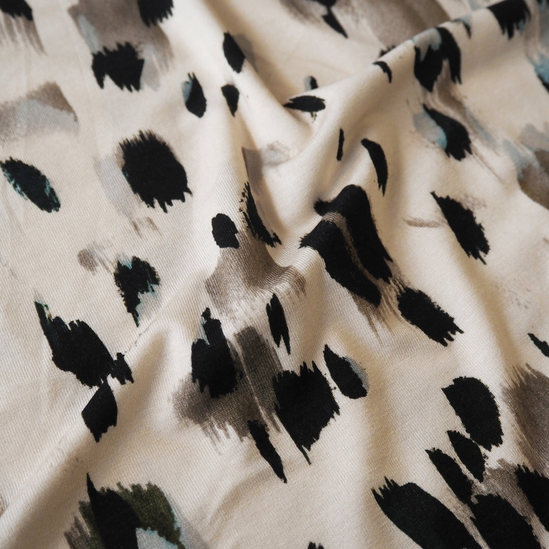 Stretchy viscose jersey dressmaking fabric with abstract pattern