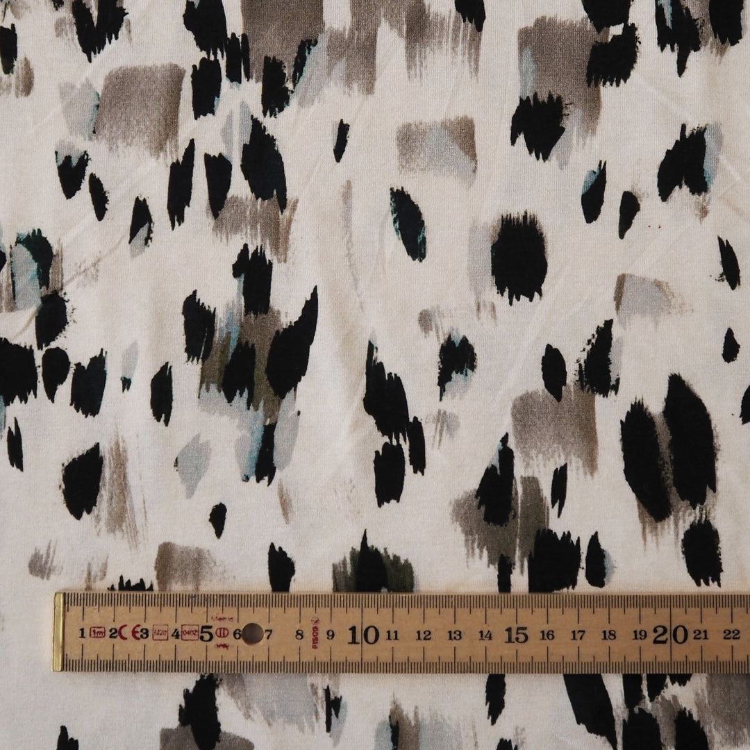 Stretchy viscose jersey dressmaking fabric with abstract pattern