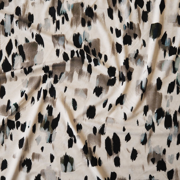 Stretchy viscose jersey dressmaking fabric with abstract pattern