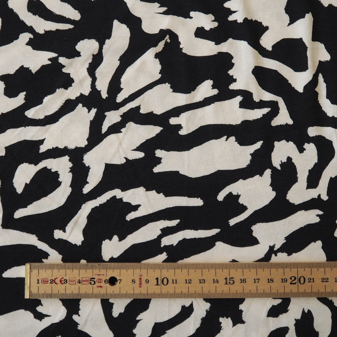 Black and cream stretchy viscose jersey dressmaking fabric with abstract pattern