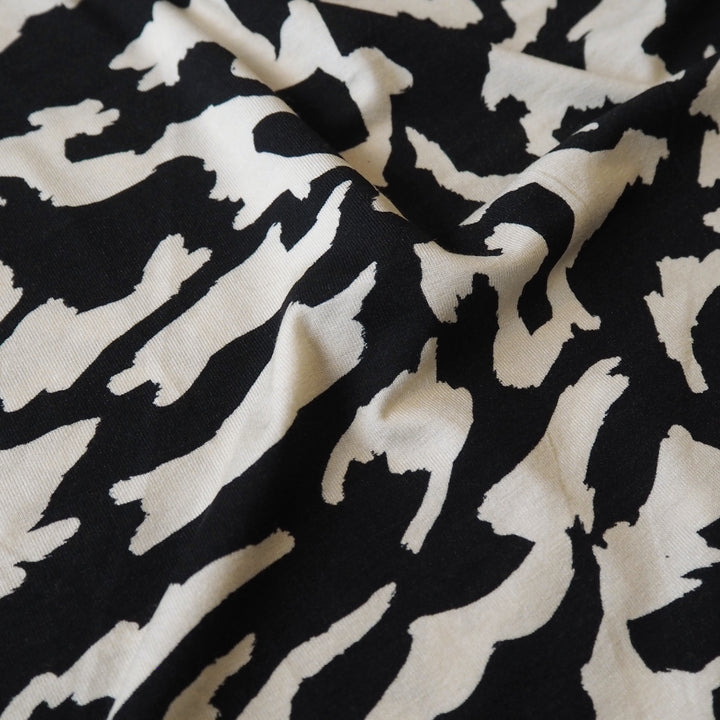 Black and cream stretchy viscose jersey dressmaking fabric with abstract pattern