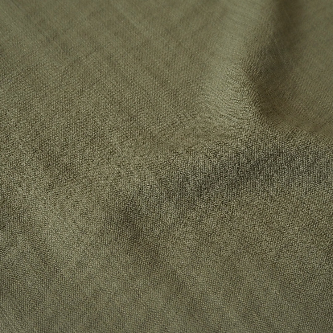 Close-up of olive green viscose blend dressmaking fabric with visible texture