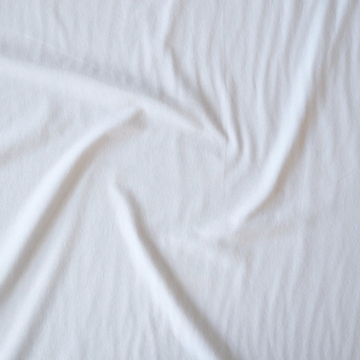 Heavy weight white cotton jersey dressmaking fabric