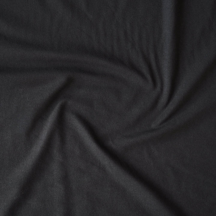 Heavy weight black cotton jersey dressmaking fabric