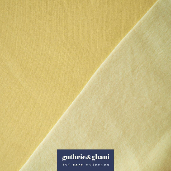 Buttercream yellow fleeceback organic cotton sweatshirting fabric, cosy and stretchy for sweatshirts and joggers.