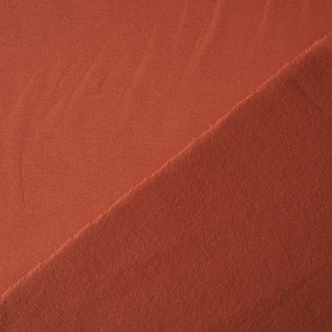 Terracotta fleeceback organic cotton sweatshirting fabric, cosy and stretchy for sweatshirts and joggers.
