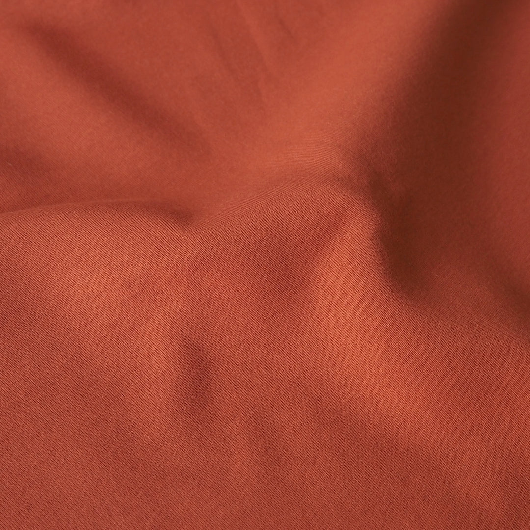 Terracotta fleeceback organic cotton sweatshirting fabric, cosy and stretchy for sweatshirts and joggers.