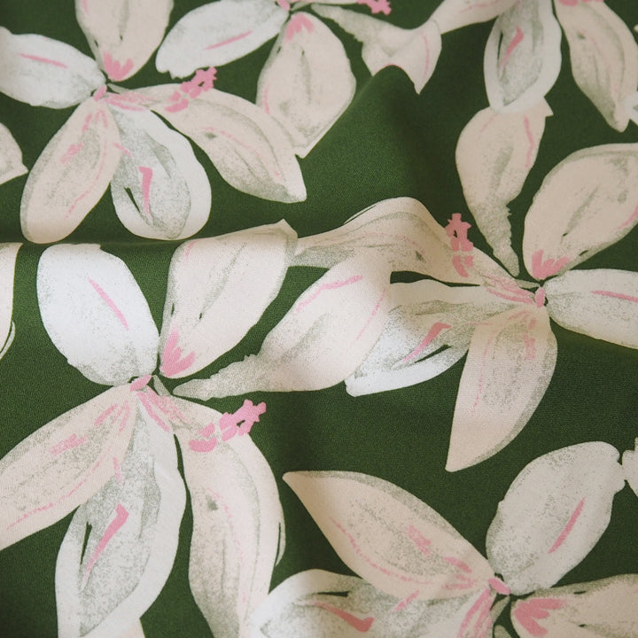 Olive tropical floral viscose fabric with pink accents for dressmaking