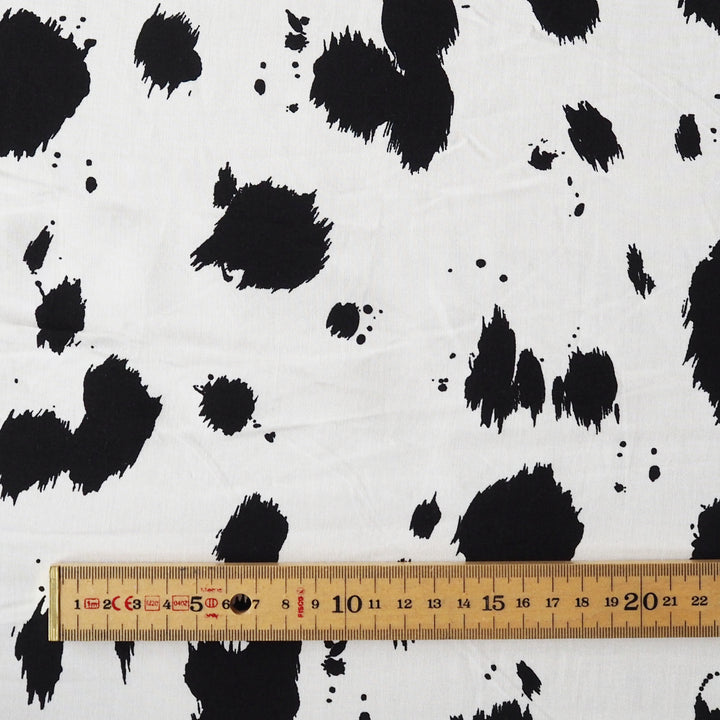 Dalmatian spots viscose dressmaking fabric in a monochrome abstract spotty print