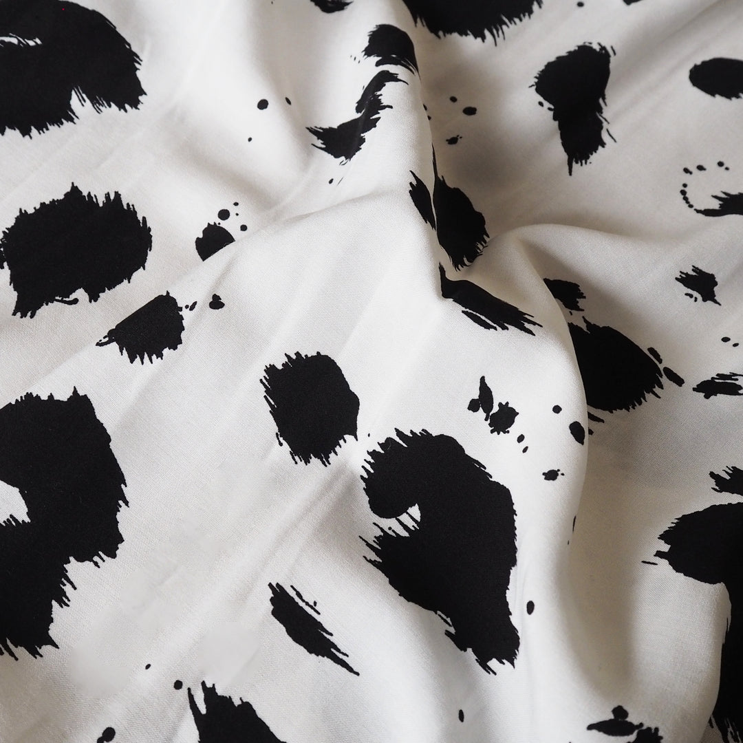 Dalmatian spots viscose dressmaking fabric in a monochrome abstract spotty print
