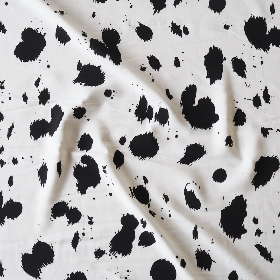 Dalmatian spots viscose dressmaking fabric in a monochrome abstract spotty print