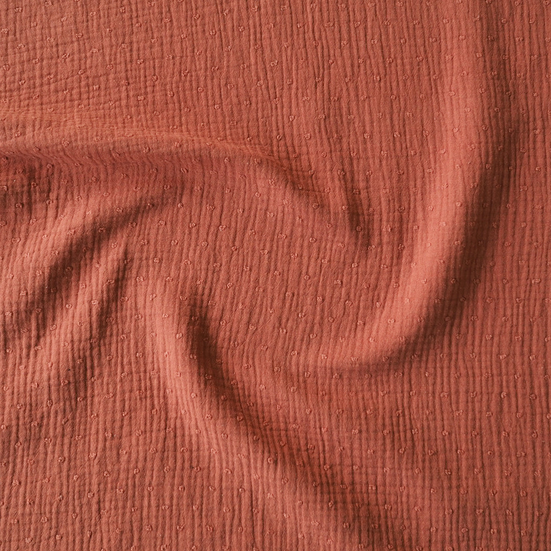 Rust dobby spot cotton double gauze dressmaking fabric