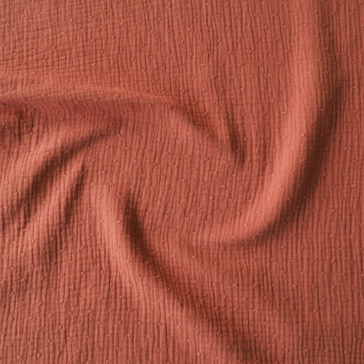 Rust dobby spot cotton double gauze dressmaking fabric