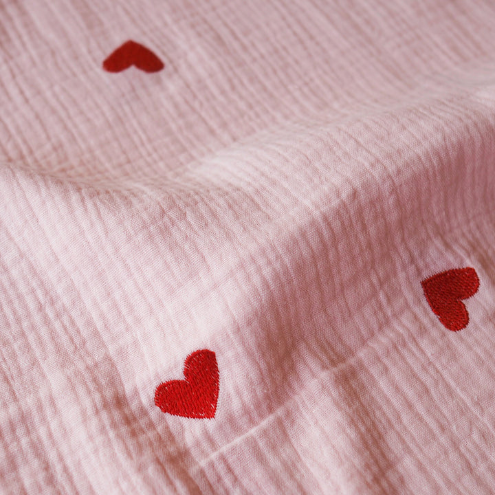 Pink cotton double gauze fabric with embroidered heart pattern for dressmaking