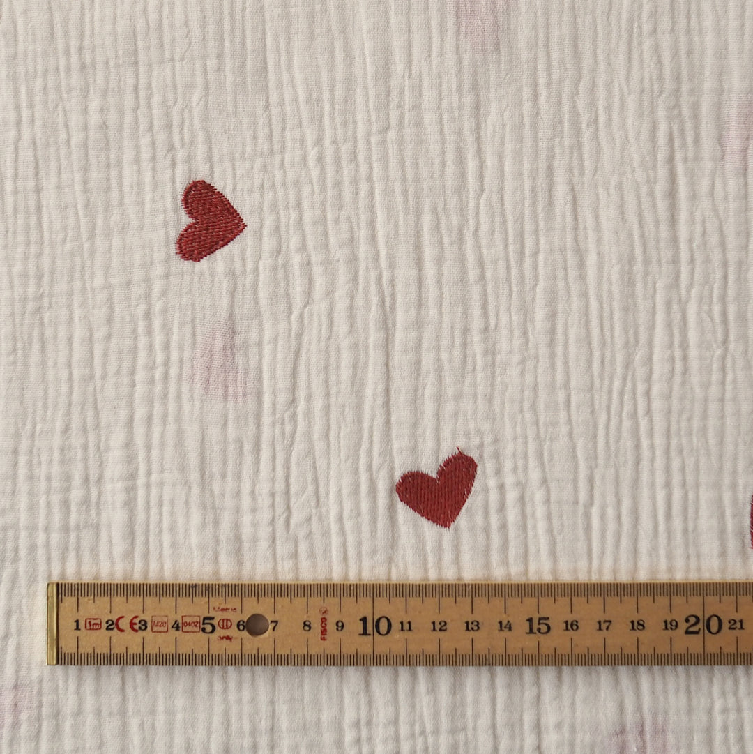 Cream cotton double gauze fabric with embroidered heart pattern for dressmaking