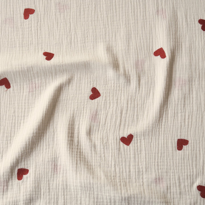 Cream cotton double gauze fabric with embroidered heart pattern for dressmaking