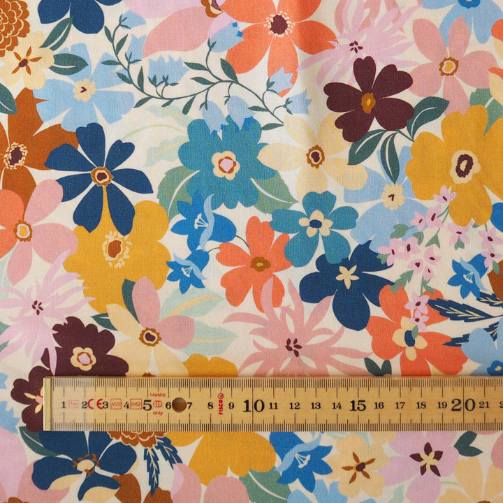 Colorful floral fabric with a ruler for scale on a white background
