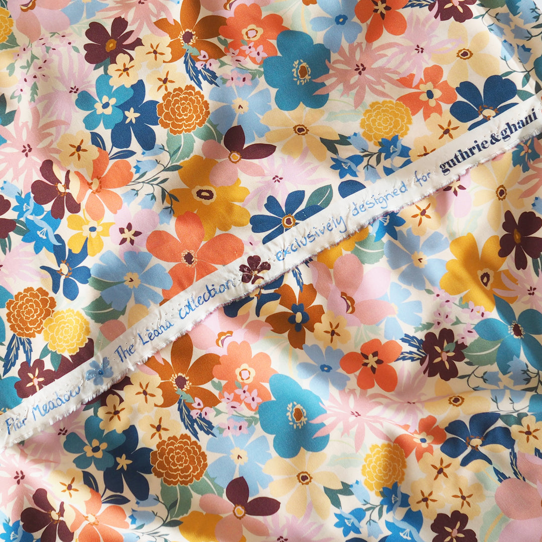 Colorful floral fabric with a visible brand name on a white background
