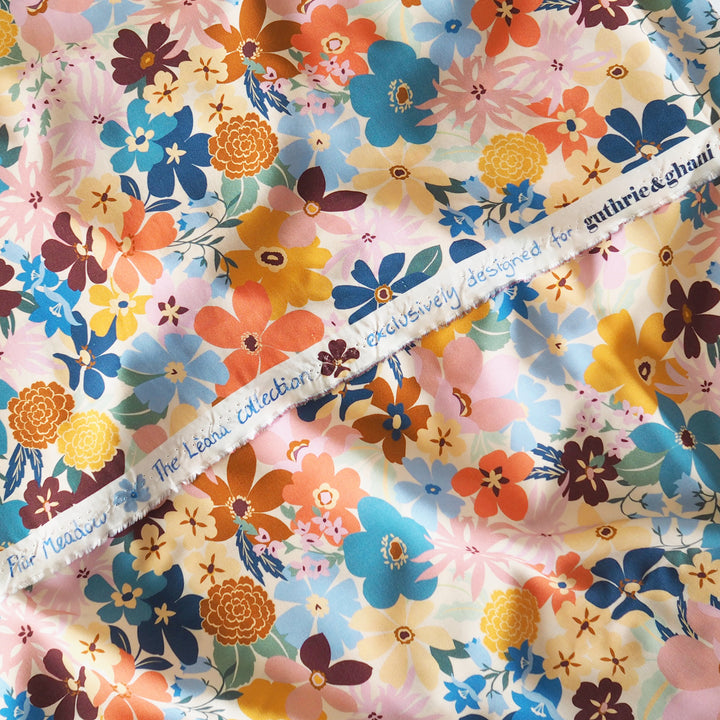 Colorful floral fabric with a visible brand name on a white background