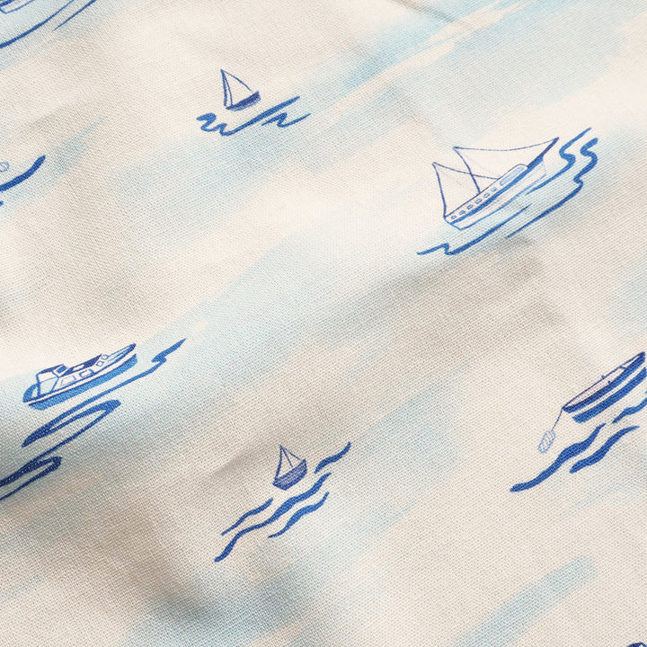 Pattern of blue boats and waves on a white background