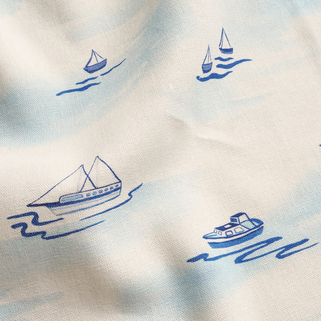 Pattern of blue boats on a white background