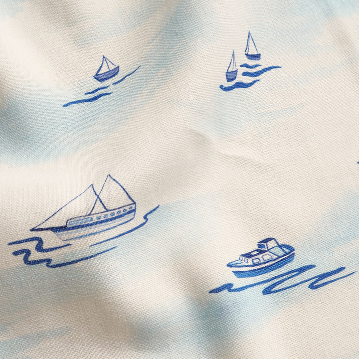 Pattern of blue boats on a white background
