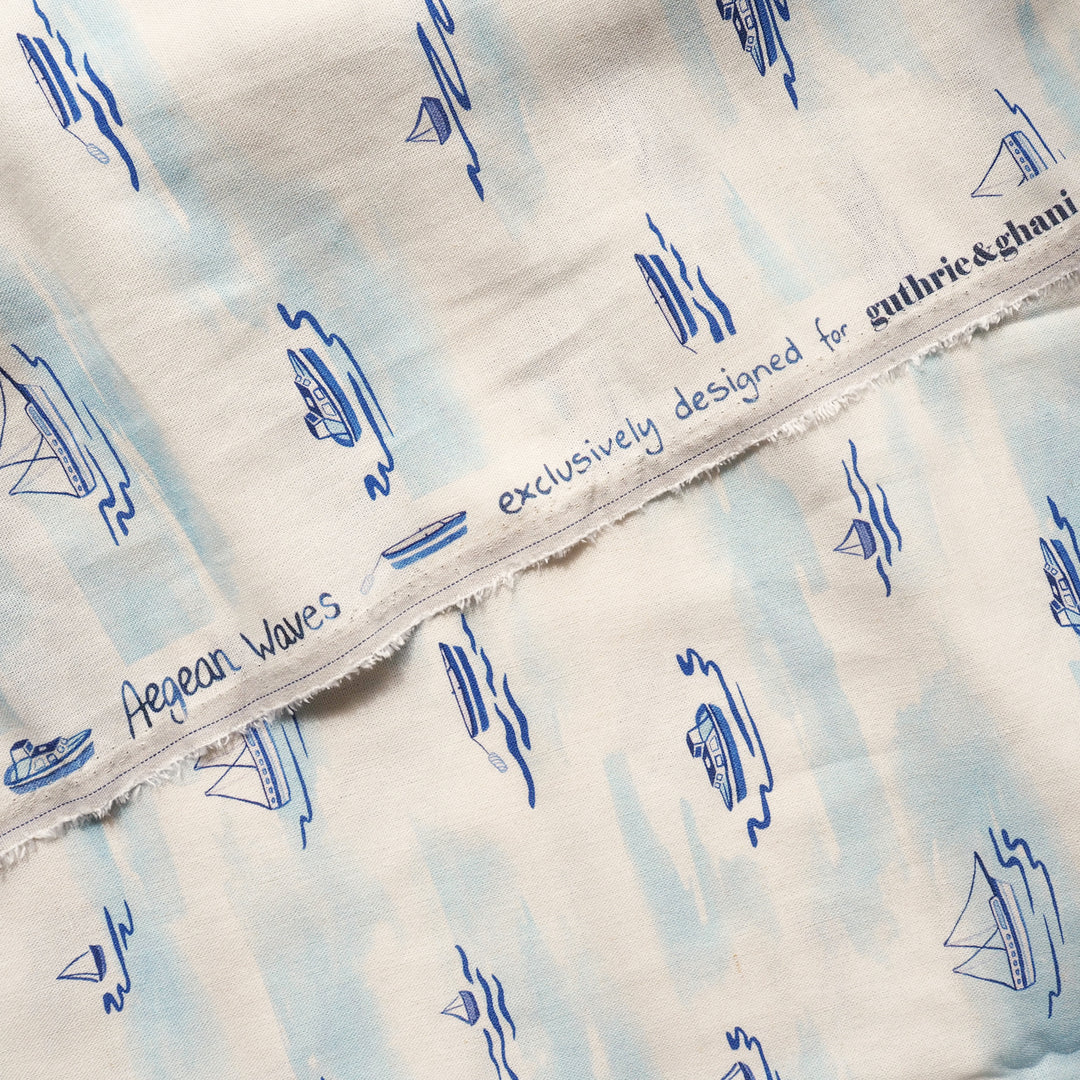 Textile with blue wave patterns and 'Guthrie & Ghani' branding on a white background