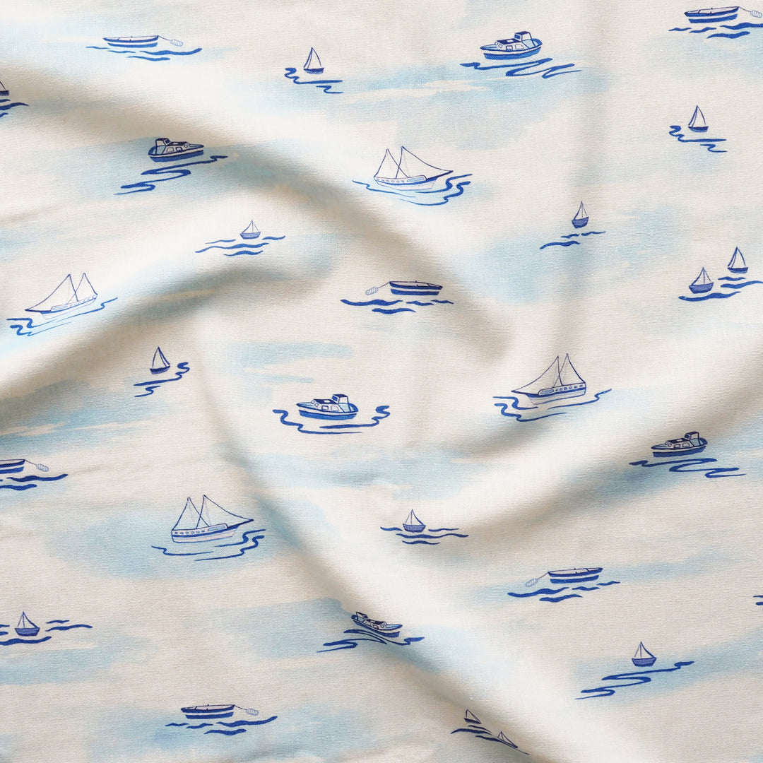 Fabric with blue boat pattern on a white background
