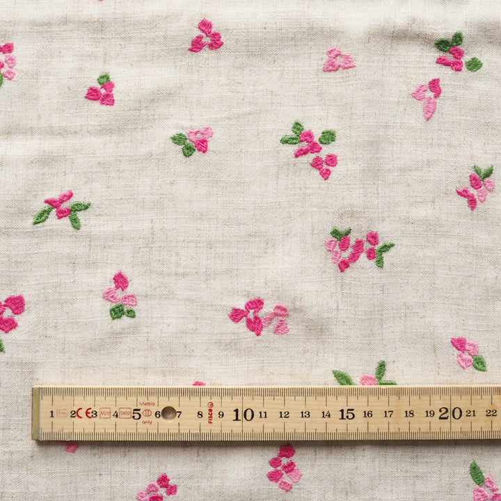 Floral embroidery on fabric with a ruler for scale