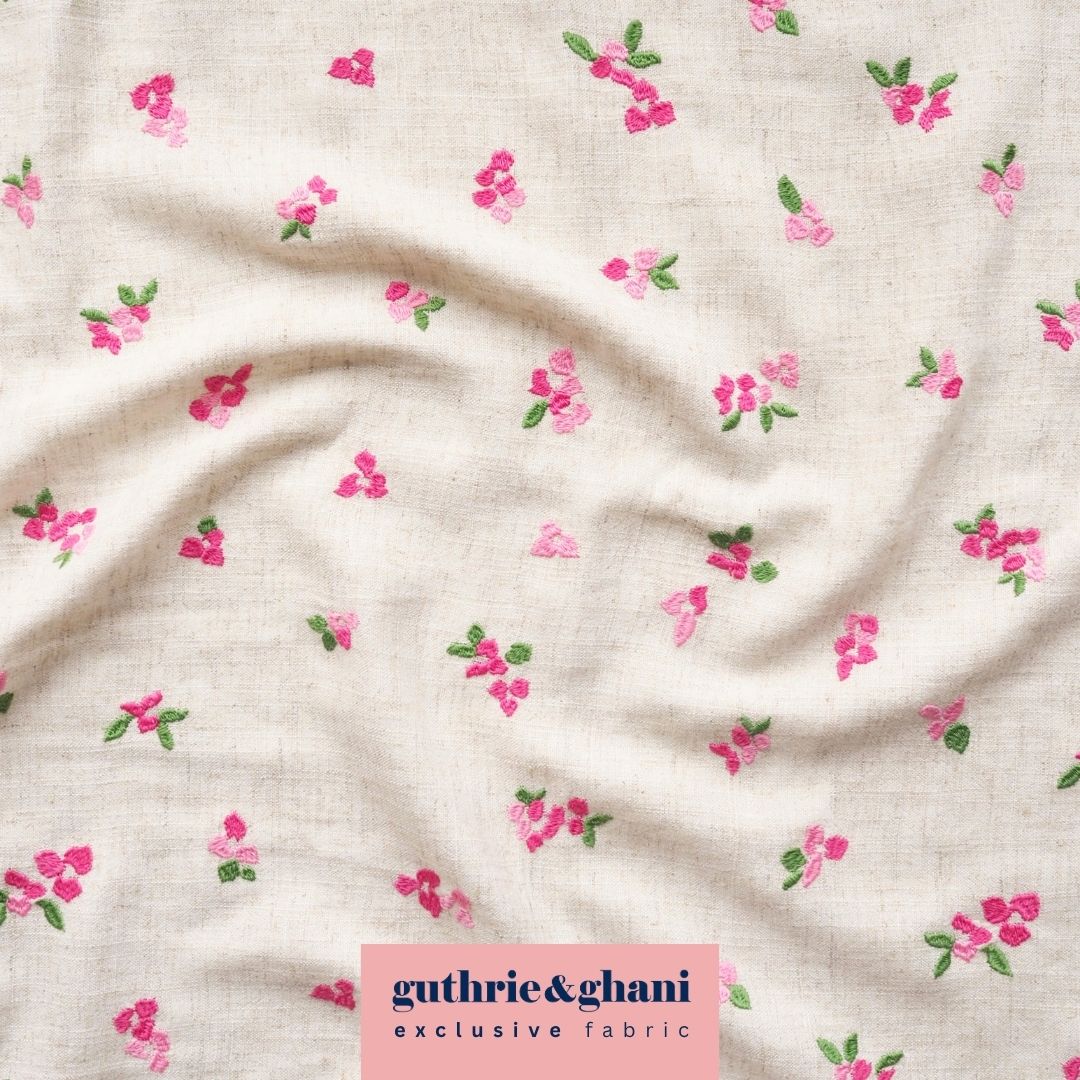 Floral patterned fabric with 'guthrie & ghani' label on a beige background