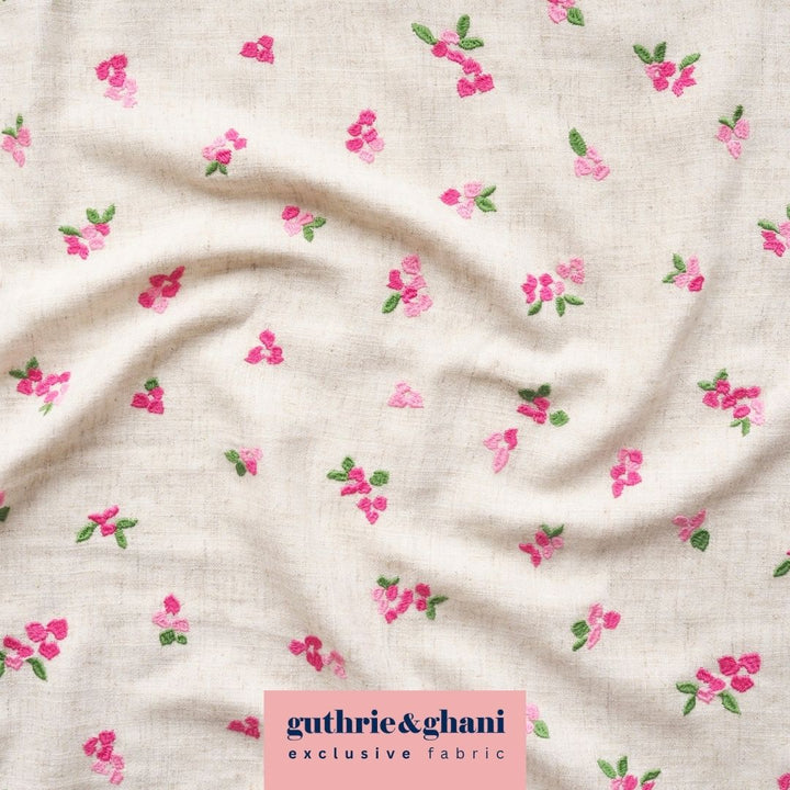 Floral patterned fabric with 'guthrie & ghani' label on a beige background