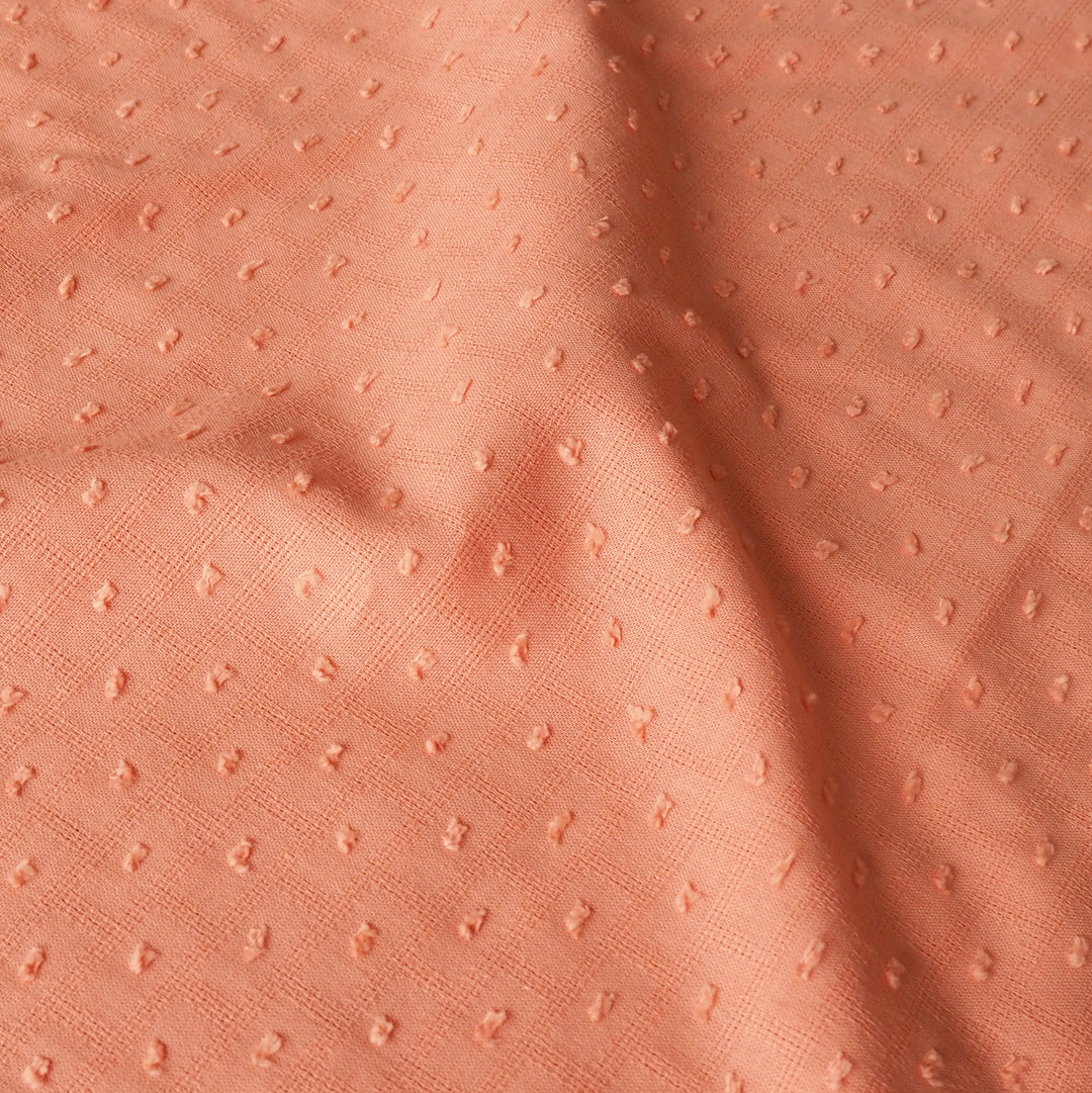 Close-up of peach textured fabric