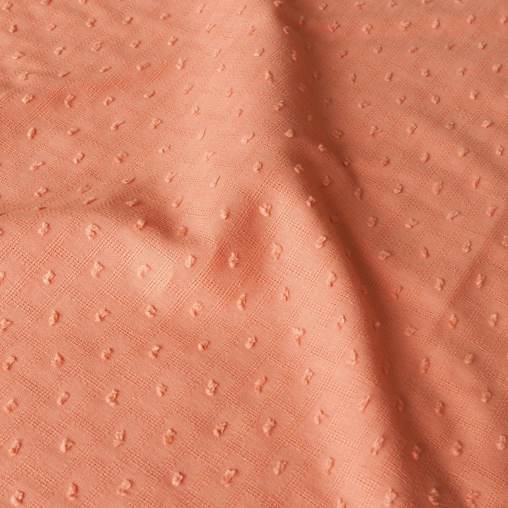 Close-up of peach textured fabric