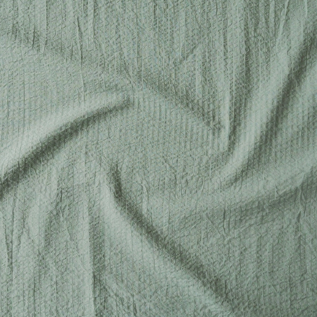 Close-up of textured green fabric