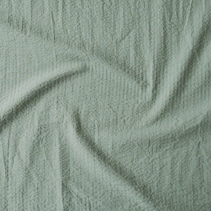 Close-up of textured green fabric