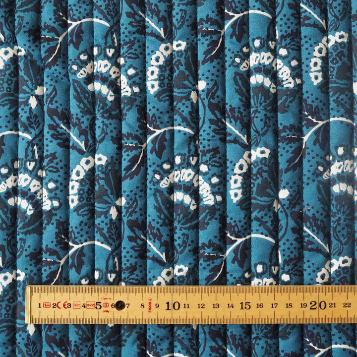 Floral patterned fabric with a ruler at the bottom for scale