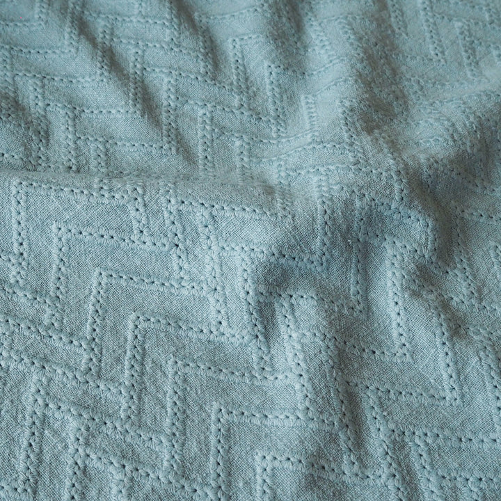 Textured teal fabric with a diamond pattern