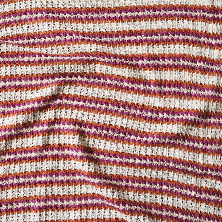 Close-up of striped fabric with pink, orange, and white pattern