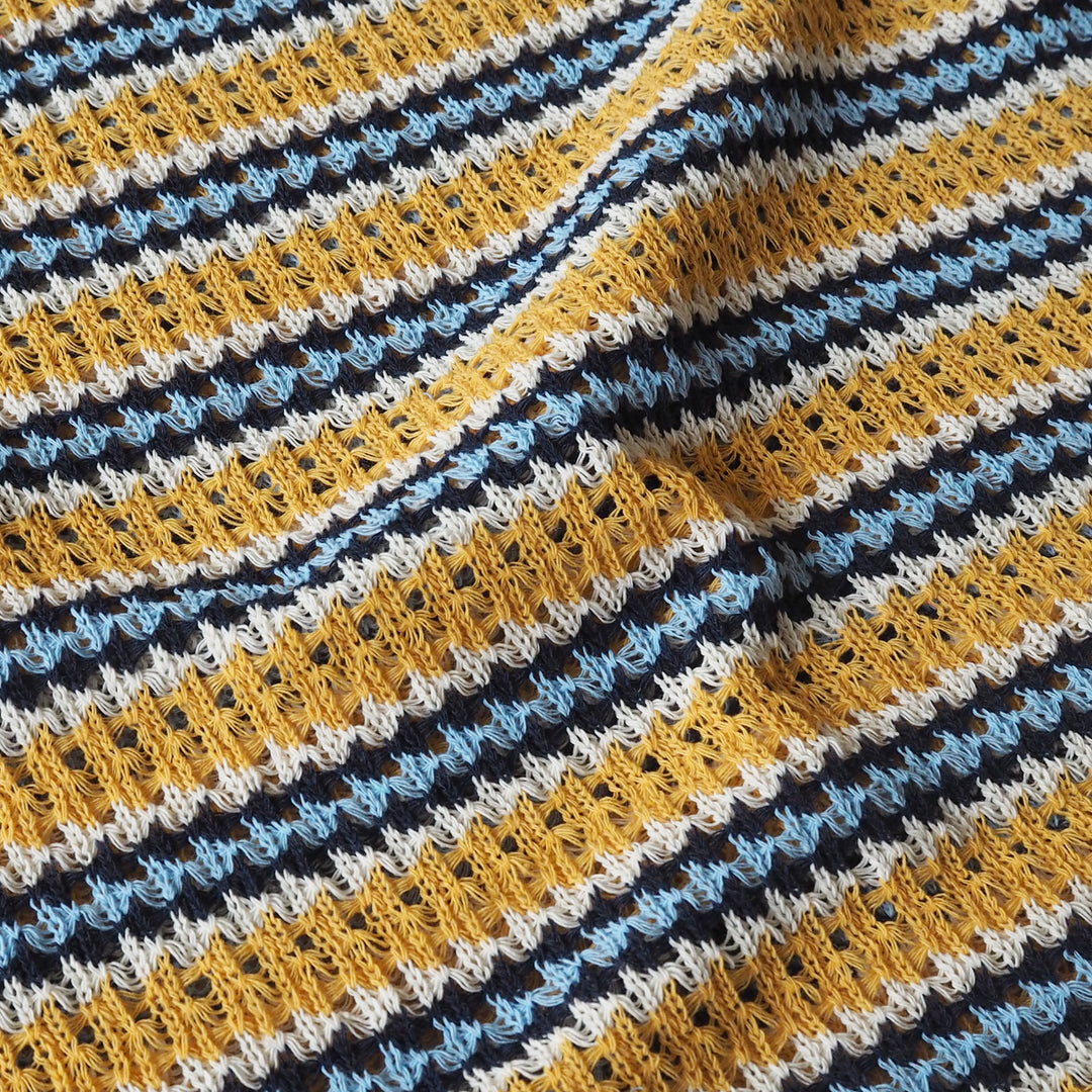 Close-up of a crocheted fabric with multicolor striped pattern