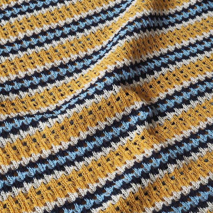 Close-up of a crocheted fabric with multicolor striped pattern