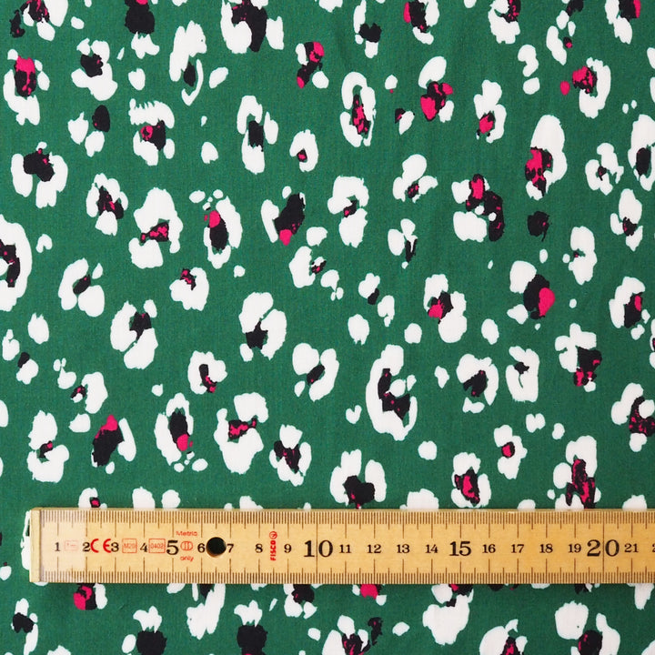Patterned fabric with a ruler for scale on a green background