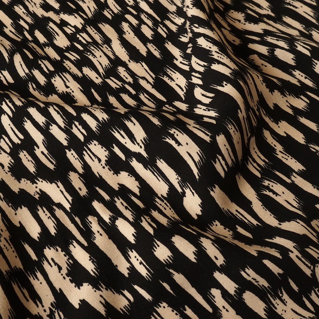 Fabric with black and beige abstract pattern
