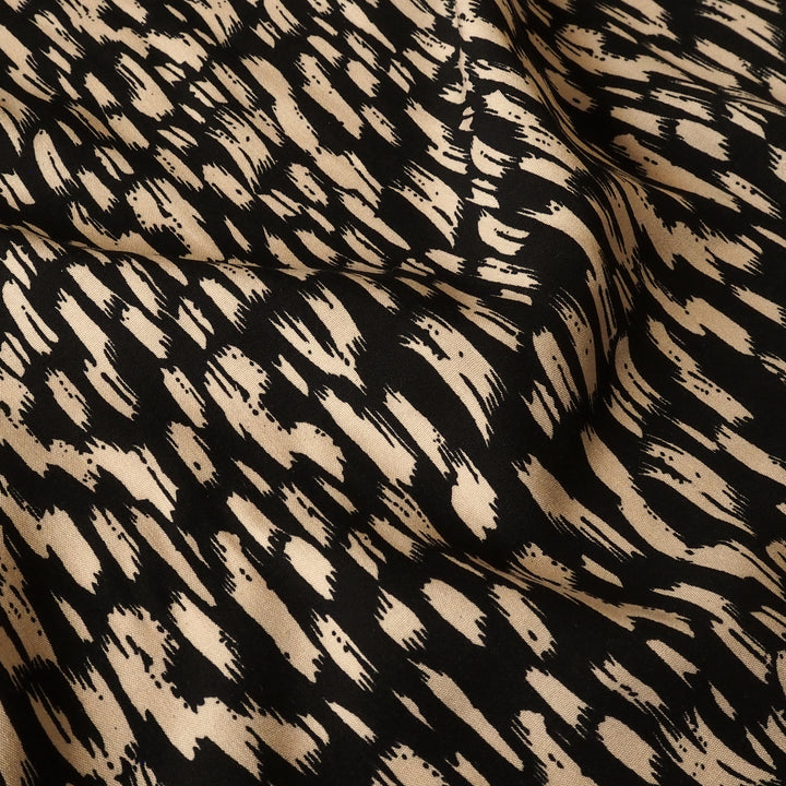Fabric with black and beige abstract pattern