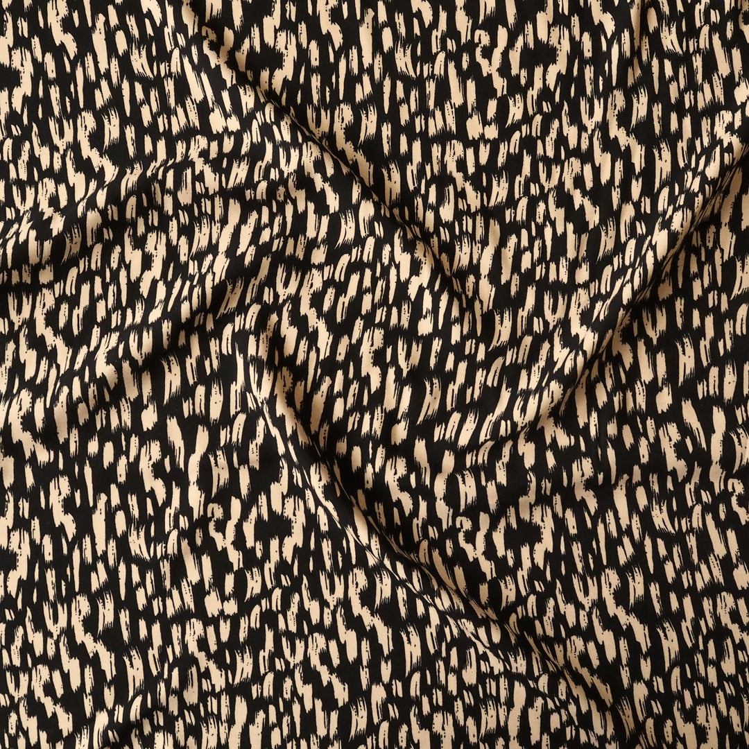 Textured fabric with a black and beige pattern