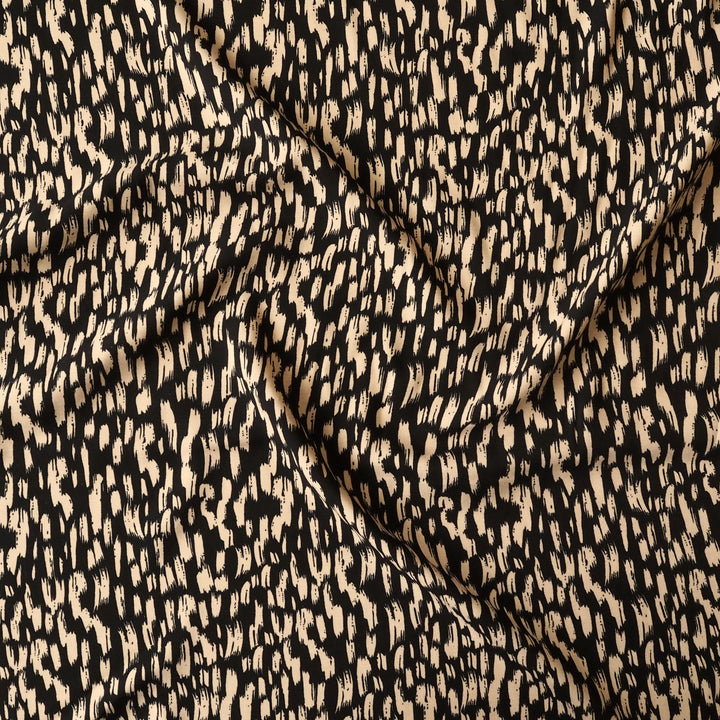 Textured fabric with a black and beige pattern