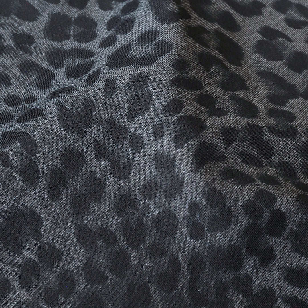 Close-up of gray fabric with black leopard print pattern