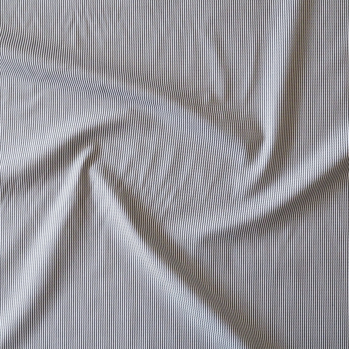 A close-up of draped fabric with a fine vertical stripe pattern in navy and off-white.