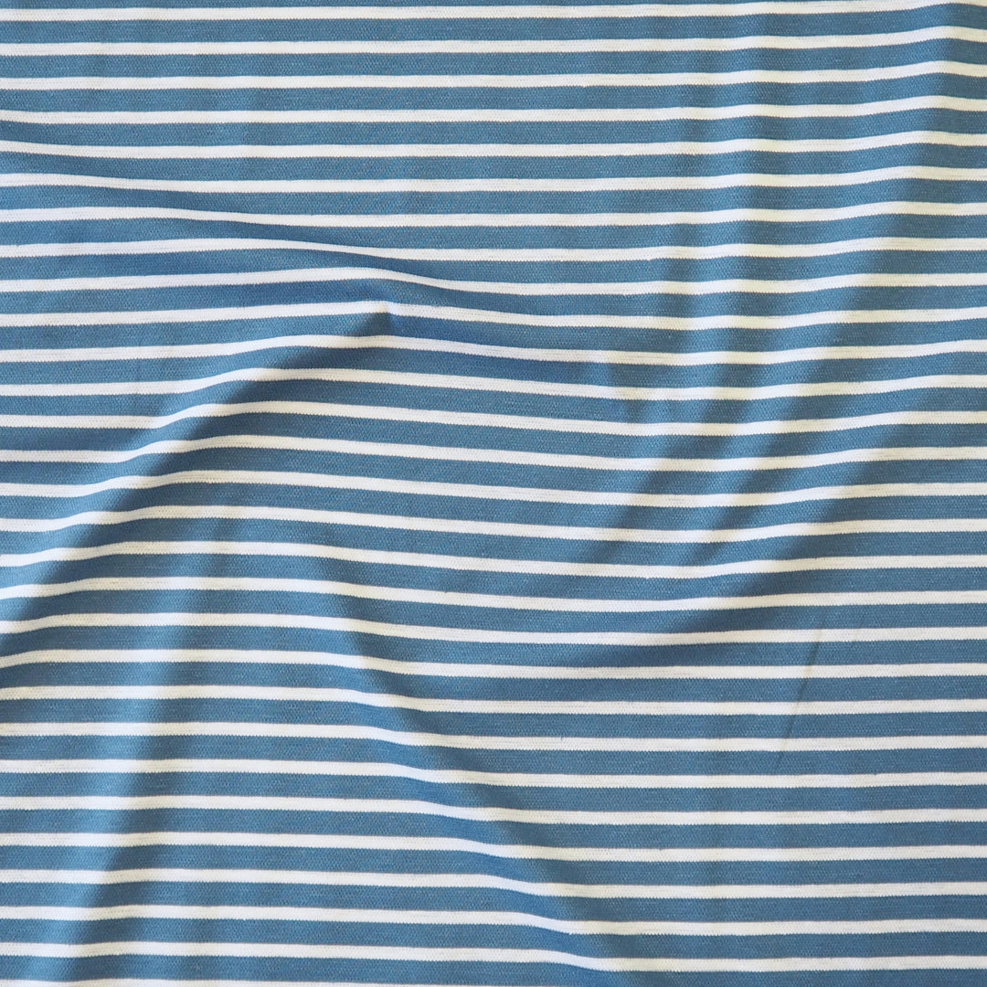 Blue and white striped fabric with a soft, draped texture.