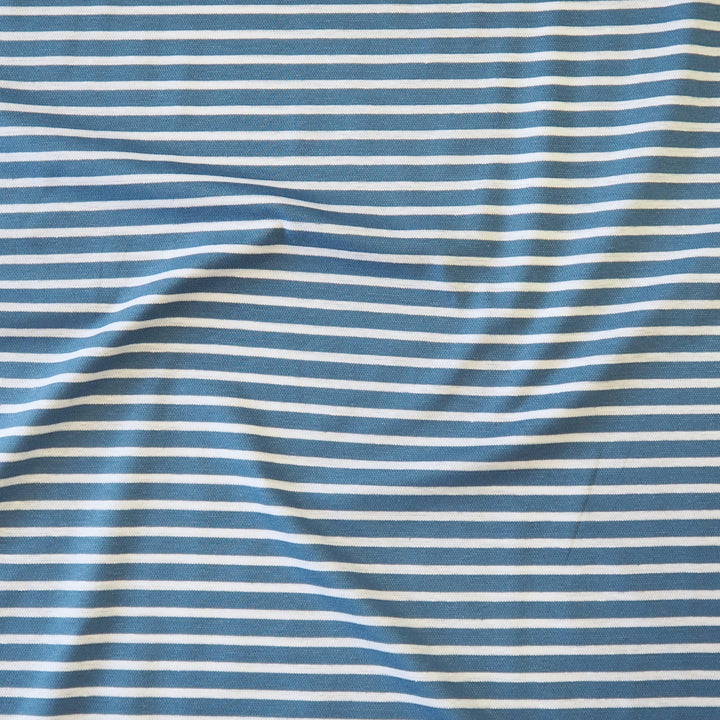 Blue and white striped fabric with a soft, draped texture.